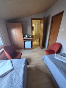 a hotel room with two beds and a bathroom at Mewa House in Jastarnia +31 photos
