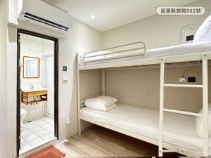 a room with two bunk beds and a sink at WE Hotel in Miaoli +26 photos