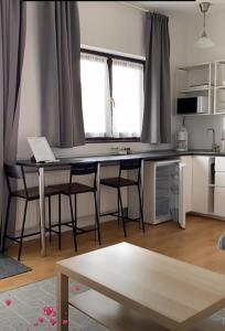 a kitchen with a table and chairs in a room at Forrás Ház Tapolca in Tapolca +115 photos