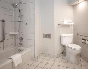 a bathroom with a toilet and a tub and a shower at Coast Lonsdale Quay Hotel in North Vancouver +64 photos