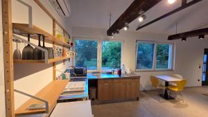 a kitchen with a counter and a table and some windows at Barrels by the Lake in Priles +49 photos