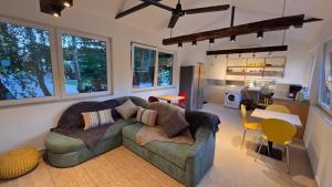 a living room with a couch and a kitchen at Barrels by the Lake in Priles