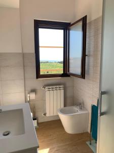 a bathroom with a tub and a sink and a window at B&B La Casetta in Ladispoli +22 photos