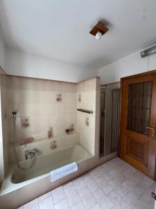 a large bathroom with a tub and a shower at La casa di Ernesto in Carlazzo +19 photos