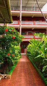 a courtyard of a building with flowers and plants at selfia guest house in Majorda