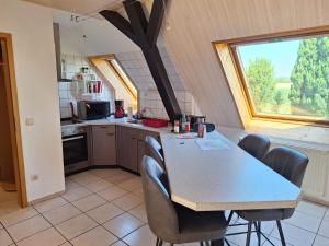 a kitchen with a table and chairs and a window at Hof Junkernberg in Bispingen +12 photos