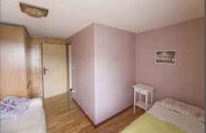 a small bedroom with a bed and a table at Dolomiti Bellunesi in Belluno
