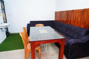a living room with a table and a couch at River side in Vagamon