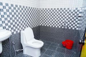 a bathroom with a toilet and a sink at River side in Vagamon
