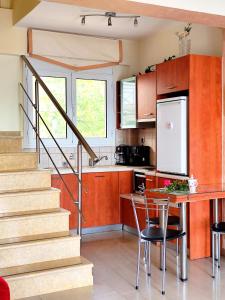 a kitchen with a staircase and a table and chairs at Villa Christine - Maisonettes with fireplace in Aliveri