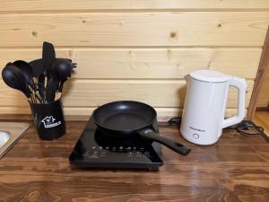 a kitchen counter with a frying pan and a coffee maker at Садиба Смугар in Rostoki