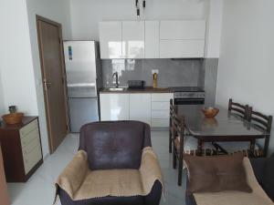 a small kitchen with a table and a refrigerator at Apartment Miki in Bar