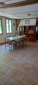 a dining room with a table and chairs at Summers Breeze in Nantheuil