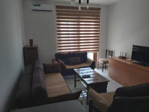 a living room with couches and a table and a television at Apartment Miki in Bar