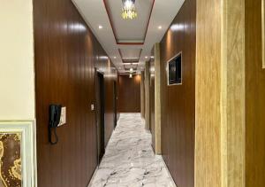 a hallway with a marble floor in a hotel room at Hotel Ganga Ram in Chitrakoot