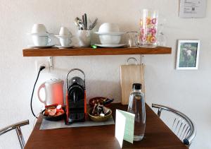 a table with a coffee maker on top of it at "Mon Rêve" Nature, Tranquility & Lake Thun in Sigriswil
