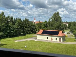a building with solar panels on the roof at Rožu romantika in Cēsis