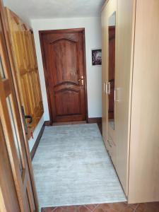 an empty hallway with a wooden door and a hallwayngth at Downtown Apartment in Plav