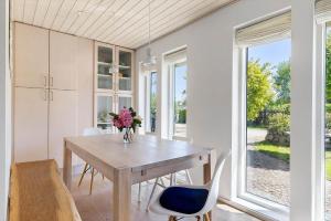 a dining room with a wooden table and chairs at 1606-Liseleje-Lisevaenget-18 in Liseleje +24 photos