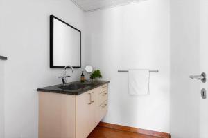 a bathroom with a sink and a mirror at 1606-Liseleje-Lisevaenget-18 in Liseleje
