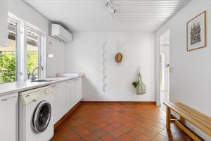 a kitchen with a washing machine and a sink at 1606-Liseleje-Lisevaenget-18 in Liseleje