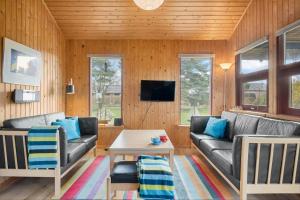 a living room with a couch and a table at 30168-Odder-Pouli-Nielsensvej-3 in Odder