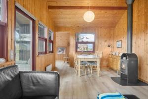 a living room with a table and a stove at 30168-Odder-Pouli-Nielsensvej-3 in Odder