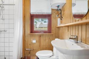 a bathroom with a white toilet and a sink at 30168-Odder-Pouli-Nielsensvej-3 in Odder +34 photos