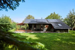 a small house with solar panels on top of it at 30168-Odder-Pouli-Nielsensvej-3 in Odder