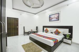 a bedroom with a large bed in a room at FabHotel Rajvanshi Palace in Gumgaon +24 photos