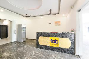 a reception desk in a room with a job horizons sign on it at FabHotel Rajvanshi Palace in Gumgaon