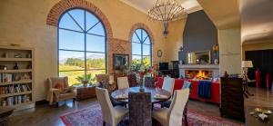 a living room with a table and a fireplace at Sandmartins in Suider-Paarl