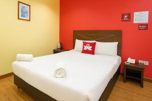 a bedroom with a large bed with a red wall at Hotel Sunjoy9 Bandar Sunway in Petaling Jaya +19 photos