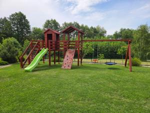 a playground with a slide in a park at Podlaska Oaza in Przejma Wielka