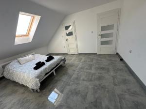 an empty room with a bed and a window at Podlaska Oaza in Przejma Wielka