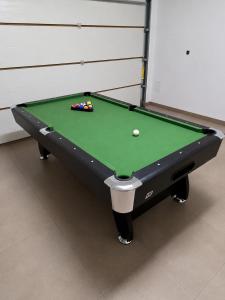 a green pool table with a ball on it at Podlaska Oaza in Przejma Wielka +18 photos