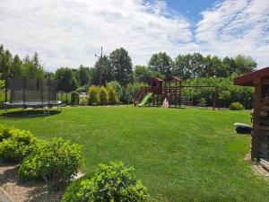 a large yard with a playground and a trampoline at Podlaska Oaza in Przejma Wielka