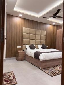 a bedroom with a large bed and wooden walls at 4 Seasons Residency in Katra