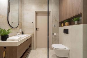 a bathroom with a toilet and a sink at Apartament Panorama Pod Dębowcem in Bielsko-Biała