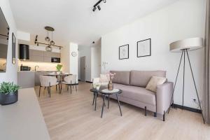 a living room with a couch and a table at Apartament Panorama Pod Dębowcem in Bielsko-Biała