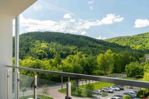 a balcony with a view of a parking lot at Apartament Panorama Pod Dębowcem in Bielsko-Biała