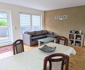 a living room with a table and a couch at Ferienwohnung Gartenblick in Fuhlendorf +37 photos