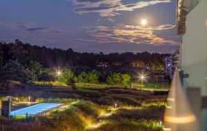 a view of a swimming pool at night at Skipper in Binz +40 photos