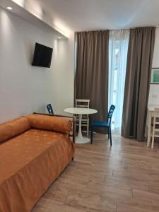 a living room with a couch and a table at Hotel Flora in Alba Adriatica