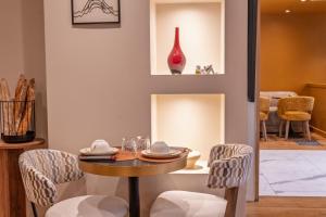 a dining room with a table and chairs at Hotel Frochot Montmartre in Paris