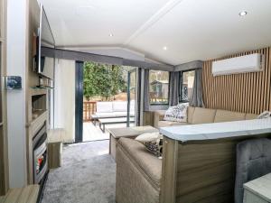 an rv living room with a couch and a table at Wild Duck Holiday Park in Belton