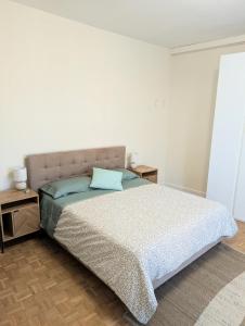 a bedroom with a bed and two night stands at Appartamento La Finestra sul Borgo in Santarcangelo di Romagna