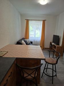 a kitchen with a table and two chairs in a room at Roda de Vael in Moena