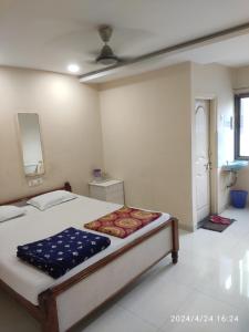 a bedroom with a bed and a bathroom with a window at Hotel heena in Bīr