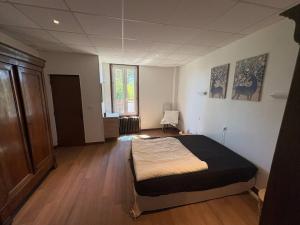 a bedroom with a bed in the middle of a room at Le Clair Briare T2 charmant in Briare